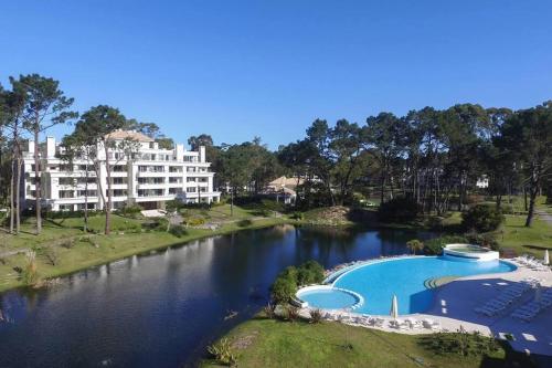 a hotel and a river with a pool at Depto PB con Jardín - Green Park in Punta del Este