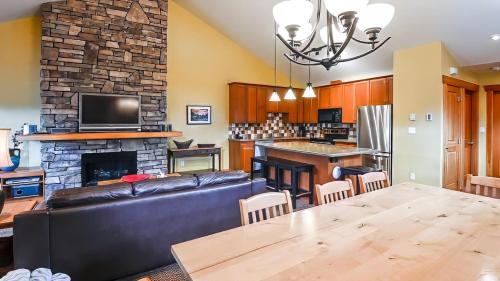 a living room with a couch and a fireplace at Pinnacle Ridge Chalets by Fernie Lodging Co in Fernie