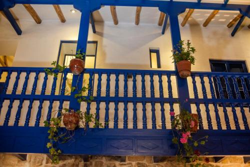 a blue staircase with potted plants on it at Rumi Wasi in Cusco