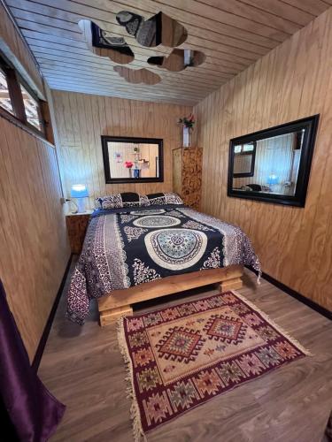 a bedroom with a bed and a rug on the floor at Paradise Rose’s in Talagante