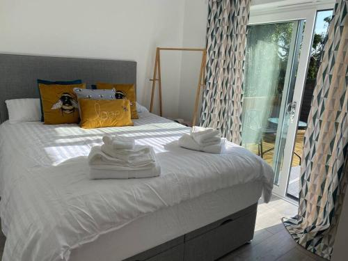 a bedroom with a bed with towels on it at Binks Bungalow in Hunstanton