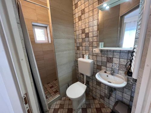 a bathroom with a toilet and a sink at Villa Angel'OK in Hévíz