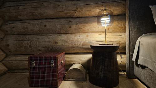 a room with a lamp and a wooden wall at Rtanj Kopaonik Eco Resort & Spa in Kopaonik