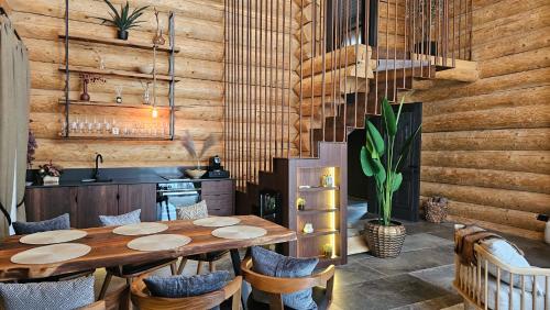 a dining room with a table and chairs at Rtanj Kopaonik Eco Resort & Spa in Kopaonik