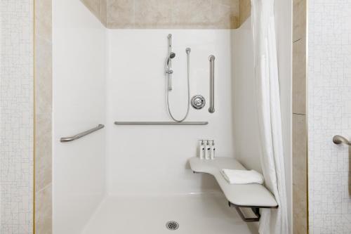 a white bathroom with a shower and a sink at Holiday Inn Express Hotel & Suites-Edmonton South, an IHG Hotel in Edmonton