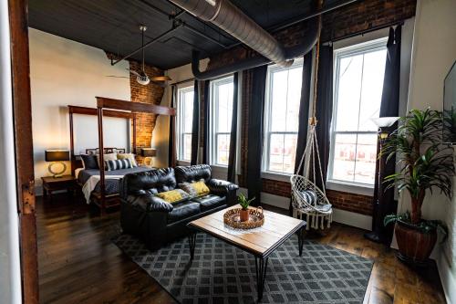 a living room with a couch and a bed at The Two Story Loft in Springfield