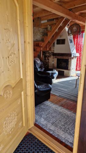 a view of a living room with couches and a fireplace at Babiogórskie Domki in Lipnica Wielka