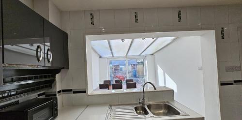 a kitchen with a sink and a window at The Crescent, 3 bed house with 2-3 parking spaces, great for contractors and family in Kent