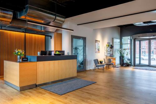 an office lobby with a reception desk and chairs at Park Inn By Radisson Wismar in Wismar