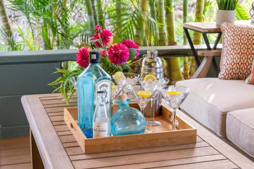 a wooden tray with bottles and glasses on a table at International Colony Club 37 in Kaanapali