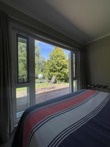 a bedroom with a bed and a large window at Guest Wing in Richmond Downs in Walton