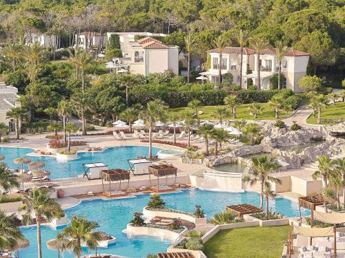 an aerial view of a resort with two pools at Grecotel La Riviera & Aqua Park in Loutra Killinis