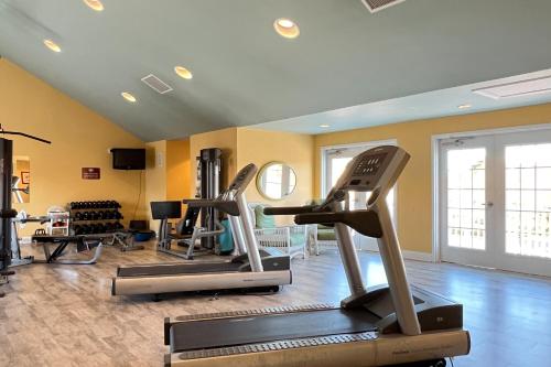 a gym with treadmills and ellipticals in a room at White Creek at Bethany --- 30930 Sea Breeze Ln in Ocean View