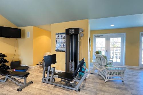 a gym with several exercise equipment in a room at White Creek at Bethany --- 30930 Sea Breeze Ln in Ocean View
