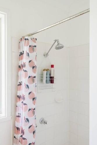 a shower curtain with hearts on it in a bathroom at Shoreline Sanctuary - A Retro Family Beach Shack in Somers