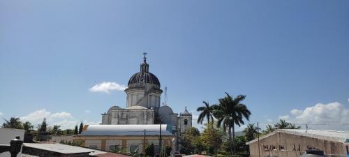 a building with a cross on the top of it at HOSTAL RIVAS INNS in Rivas