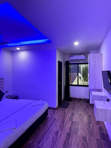 a bedroom with a bed and a blue ceiling at Hotel heaven by sky in Calangute