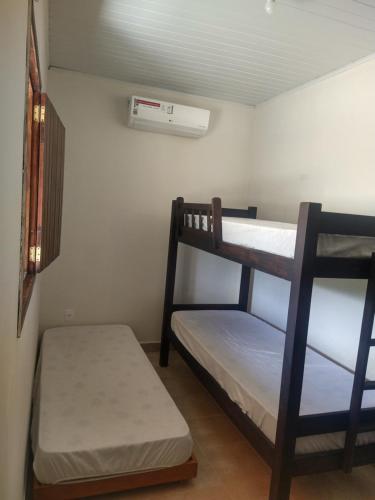 a room with two bunk beds and a fan at Chalé Santa Rita in Bonito