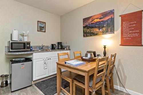 a small kitchen with a table and a microwave at Mountain Meadows Inn & Chalet Suites in Ashford