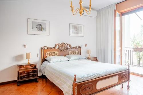 um quarto com uma cama grande e um lustre em Appartamento 400 mt Stazione Linea S1 Milano em San Giuliano Milanese