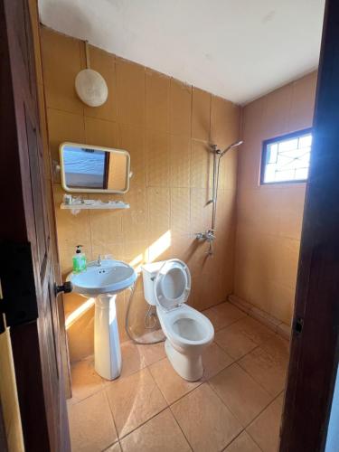 a bathroom with a toilet and a sink at Mary Home Stay Riverside in Luangprabang in Luang Prabang