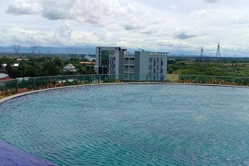 a large swimming pool on top of a building at Student Haven Compact Studio at B Residence BSD in Cilandak