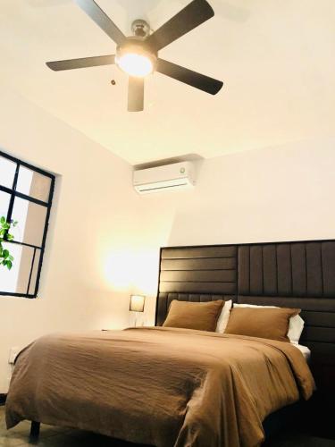 a bedroom with a bed with a ceiling fan at Leveli Coliving in Guadalajara