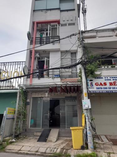 a tall white building with a balcony on it at Homestay Linh in Ho Chi Minh City