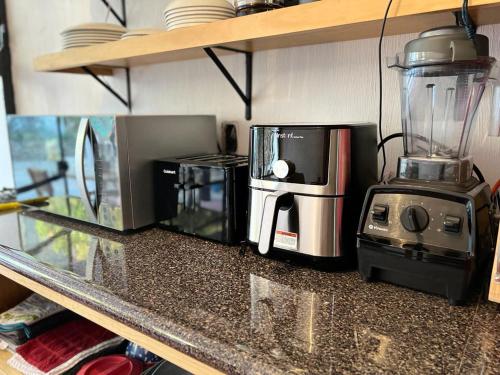 a kitchen counter with a coffee maker and a blender at Leveli Coliving in Guadalajara