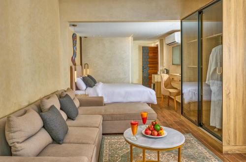 a living room with a couch and a bedroom at Cleopatra Tower Pyramids View in Cairo
