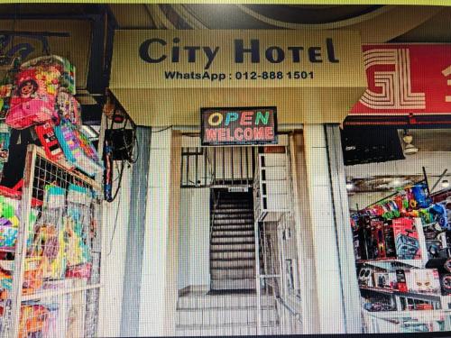 a city hotel with an open sign in a store at City hotel in Sibu