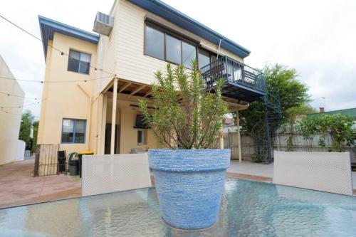 a large blue pot with a plant sitting on top of a pool at Richmond Delights - 4 Bedrooms and a Big Backyard in Melbourne