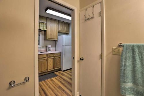a kitchen with a white refrigerator and wooden cabinets at Escambia in Tallahassee