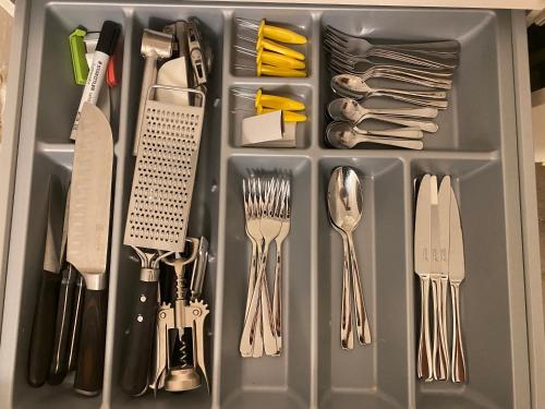 a drawer filled with utensils and forks and knives at Shared apartment in former hotel, near train station, fully equipped kitchen with washer-dryer in Hürth