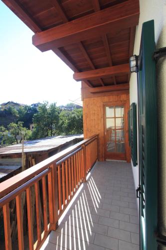 a balcony of a house with a wooden door at Appartamento Diana in Cavalese