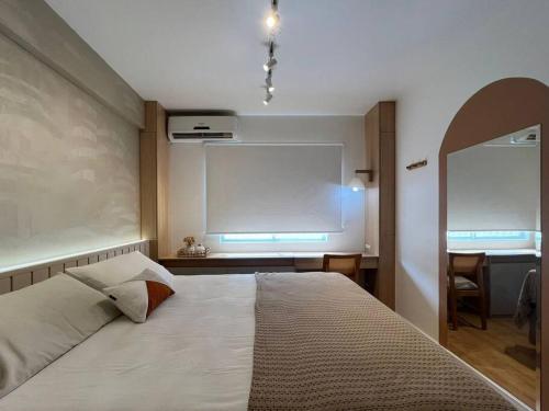 een slaapkamer met een groot bed en een raam bij Apartamento na Quadra do Mar com pisicina in Balneário Camboriú