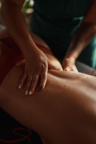 a woman getting a massage on her stomach at Cocli Hotel Boutique Salento in Salento