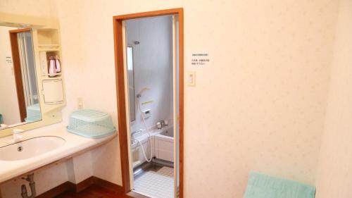 a bathroom with a shower and a sink and a tub at Tabino Camping Base Kami Yuland - Vacation STAY 52574v in Osaki