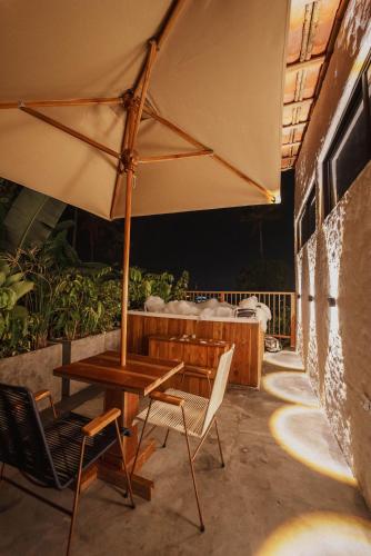 a table and chairs with an umbrella on a patio at Cocli Hotel Boutique Salento in Salento