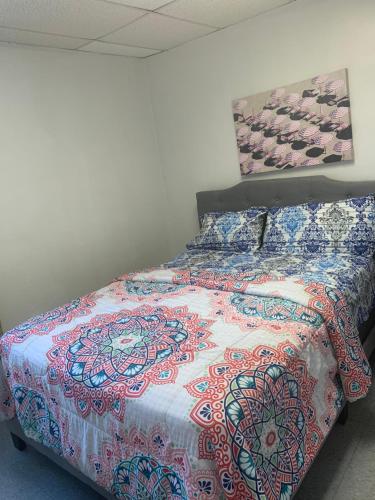 a bedroom with a bed with a colorful bedspread at Muna’s Place in Newark