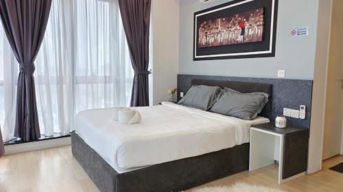 1 dormitorio con 1 cama grande y TV en la pared en A3. The Sun @ Revo Aurora Pavillion, en Kuala Lumpur