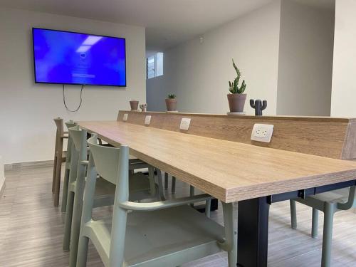 a conference room with a large wooden table and chairs at House between Poblado and Laurels / Casa en Belen al frente de la unidad deportiva. Medellín in Medellín