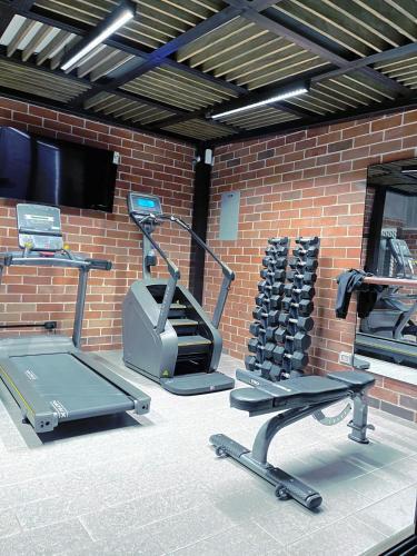 a fitness room with a brick wall and a gym at Nuevo y Moderno Apartamento con Parqueo en la atractiva Zona 4 in Guatemala