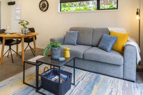 a living room with a couch and a table at Central City-Urban Oasis 1 bed 1 bath w/sofa bed in Christchurch