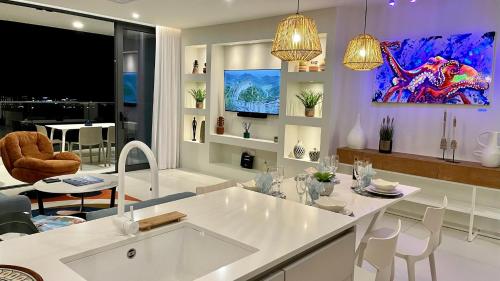 a kitchen and dining room with a white table and chairs at Gorgeous 2 bedroom, 17th floor, with breathtaking view, Fourteen at Mullet Bay in Cupecoy
