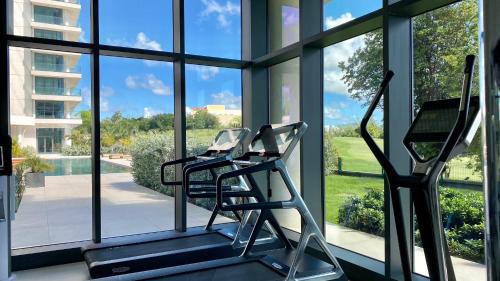 a gym with two treadmills in front of a window at Gorgeous 2 bedroom, 17th floor, with breathtaking view, Fourteen at Mullet Bay in Cupecoy