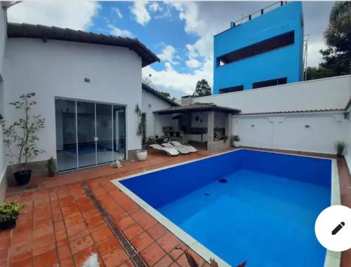 a swimming pool in front of a house at Casaclassea in Juiz de Fora