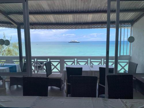 a dining room with a view of the ocean at Le Recif Hotel Rodrigues in Rodrigues Island