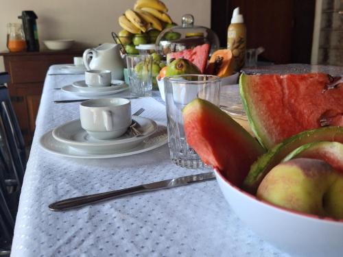 a table with a bowl of fruit on a table at Pousada Solar do Redentor in Rio de Janeiro