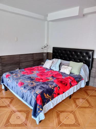 1 dormitorio con 1 cama grande y cabecero negro en Studio Luna, en Pereira